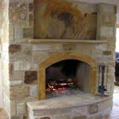 a stone fireplace with an open fire place