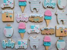 decorated baby shower cookies are displayed on a marble countertop, including ones that say it's a boy