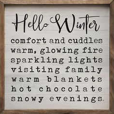 a wooden framed sign that says hello winter comfort and cuddles warm, glowing fire sparkling