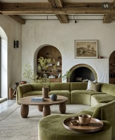 a living room filled with furniture and a fire place in the middle of the room