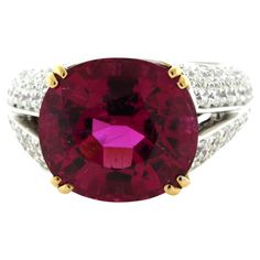 Simply stunning! The ring features an amazing 9.42 carat rubellite tourmaline with the most bright vivid and vibrant color we have seen in a long time! It is a rich pinkish-red color that will make you smile and feel warm inside. It is complemented by 2.46 carats of pave-set diamonds set around the ring adding brilliance and sparkle to the piece. Made in platinum with 18k yellow gold prongs holding the tourmaline. Ring Size 7 Weight: 11.4 grams Kubler Ross, Ruby Jewel, Diamond Gold Ring, Cowry Shell, Woman Jewelry, Rubellite Tourmaline, Mens Rings, Pinkish Red, Platinum Diamond Rings