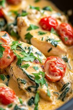 chicken with tomatoes and spinach in a yellow sauce