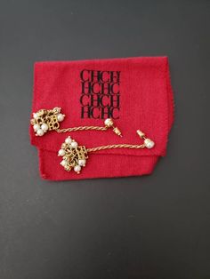 "This is a beautiful pair of Carolina Herrera pierced earrings. They feature a gold chain with Faux pearls. MEASUREMENTS: approx. 2 1/4\" (5.6 cm) x 1\" (2.5 cm) SIGNATURE: CH logo red pouch CONDITION: They are in gently used vintage condition with no issues . Take a look at my other items http://www.etsy.com/shop/Jewelrin" Elegant Gold Earrings With Logo Charm, Frog Pins, Bezel Necklace, Faux Pearl Earrings, Butterfly Brooch, Fashion Logo, Pierced Earrings, Carolina Herrera, Earings Piercings