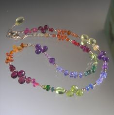 "So colorful, so sparkly, so tactile.  An array of gorgeous gemstones, like a rainbow, are accented with a few tiny 1.8mm sterling beads. The pump amethyst briolettes are 6mm. All the tiny sapphires are approximately 4mm.  The lemon quartz briolettes are 6.5mm. The bright trio of cherry red spinel is 4mm.  Gemstones: Lemon quartz Sapphires in orange and pink Red spinel Purple garnet Peridot Tsavorite Apatite Tanzanite Amethyst Spessartite Rhodolite garnet Vesuvianite Kyanite Length adjusts from Rainbow Multi-stone Gemstones For Jewelry Making, Amethyst Multi-stone Briolette Gemstones, Gift Multi-stone Round Beads Gemstones, Amethyst Briolette Multi-stone Gemstones, Elegant Rainbow Gemstones For Jewelry Making, Rainbow Multi-stone Unique Jewelry, Unique Multi-stone Rainbow Jewelry, Unique Rainbow Multi-stone Jewelry, Multicolor Multi-stone Amethyst Jewelry