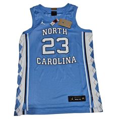 Show Your Love For The North Carolina Tar Heels With This Nike Unc Michael Jordan #23 Jersey. The Blue Jersey Is Made Of High-Quality Materials And Features Jordan's Name And Number On The Back. It's Perfect For Basketball Enthusiasts And Fans Of The Ncaa. This Officially Licensed Nike Jersey Is Designed For Men In Size Medium. It's A Great Addition To Any Fan's Collection And Is Perfect For Wearing During Regular Season Games Or While Cheering On Your Favorite Team. Get Your Hands On This High- Sleeveless Blue Tops For College, Collegiate Blue Sleeveless Tops, Blue Sleeveless Collegiate Tops, Blue Sleeveless Collegiate Style Top, Nike Blue Collegiate Tops, Jordan Name, Jordan 23 Jersey, Michael Jordan 23, Nike Jersey