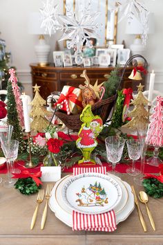 a christmas table setting with plates and silverware