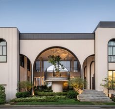 an architecturally designed building with arched windows and stairs leading up to the second floor