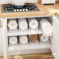 an open cabinet with plates and pans in it