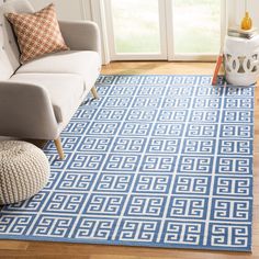 a blue and white rug in a living room