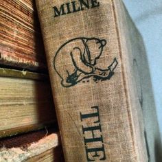 an old book sitting on top of a pile of books with the word mine written on it