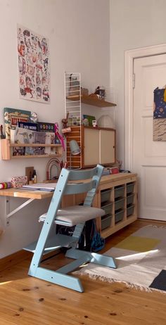 a chair sitting on top of a hard wood floor next to a wooden shelf filled with books