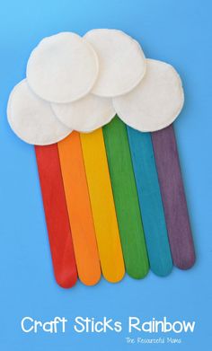 rainbow popsicle craft for kids with paper clouds on top and the words craft sticks rainbow above them