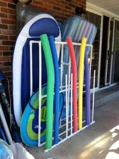 several surfboards are lined up in front of a door with a rack on it