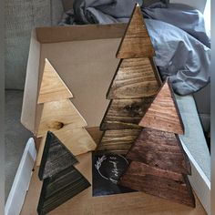 three wooden christmas trees sitting in a box