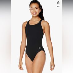 a woman in a black swimsuit posing for the camera