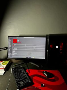 a computer monitor sitting on top of a desk next to a keyboard and mouse,