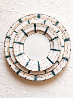 three plates are stacked on top of each other in the shape of an abstract design