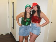 two girls in sequin tops and denim shorts posing for the camera with their arms around each other