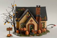 a small house with pumpkins on the front