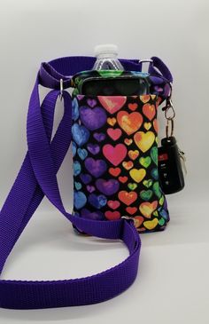 a cell phone case with hearts on it and a lanyard attached to the strap