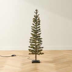 Studded with twinkling white LED lights, faux pencil pine tree is a modern take on the traditional Christmas tree with the look of freshly cut pine. The slim silhouette is ideal for smaller spaces. Pair with the 6' and 7.5' faux pencil pine Christmas trees to create a layered holiday display. CB2 exclusive.  -Iron frame with blend of PPE/PVC branch tips -Cement base -Pre-lit with white LED bulbs -For indoor and sheltered outdoor use -Imported Faux Pencil Pine Christmas Tree 4' Pencil Pine, Holiday Mantel Decor, Modern Christmas Ornaments, Unique Holiday Decor, White Christmas Ornaments, Holiday Mantel, Pine Christmas Tree, Tree Collar, Modern Christmas Decor