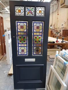 a black door with stained glass windows in it