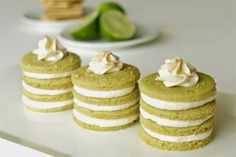 three cookies with white frosting and limes in the background