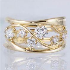 a gold ring with three diamonds on it