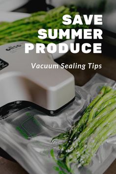 a vacuum sealer sitting on top of a plastic bag next to asparagus