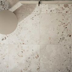 an overhead view of a bathroom with marble flooring and white fixtures on the wall