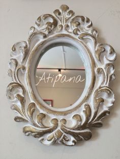 an ornate mirror hanging on the wall