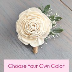 a white flower with the words choose your own color in front of it on a wooden surface