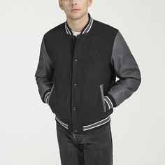 Elevate your look with the Levi's Men's Mixed Media Bomber Jacket, crafted with a stylish blend of wool and sleek faux leather. Designed with a banded hemline, neckline, and cuffs for a tailored fit, it features a full zipper and snap closure for versatile wear, along with two side slip pockets for everyday convenience. Don't miss out on this must-have piece to upgrade your wardrobe.Features: Elastic BottomClosure Type: Snap & ZipperNeckline: Collar NeckPockets: 2 Side Slip Pockets, 1 Inside Cel Varsity Outerwear With Button Closure For Work, Fitted Varsity Outerwear For Work, Classic Black Wool Varsity Jacket, Wool Outerwear With Button Closure For Streetwear, Winter Varsity Style Outerwear For Work, Black Wool Varsity Jacket For Fall, Black Wool Outerwear For College, Classic Wool Outerwear For College, Wool Outerwear For College In Fall