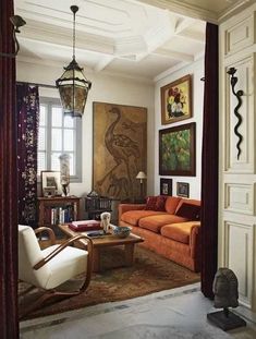 a living room filled with furniture and paintings