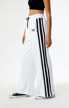 PacSun exclusive! Introducing the Coney Island Picnic x Everlast Wide Leg Track Pants, a winning combination of retro aesthetics and contemporary comfort. Crafted for both style and functionality, these track pants boast a wide-leg silhouette that nods to vintage sportswear while ensuring a modern fit. Featuring contrast side stripes and pintuck details, these pants add a touch of athletic flair to your look. With the iconic collaboration embroidery at the hip, these high-waisted pants are the perfect blend of nostalgia and streetwear flair.


	Solid color track pants
	28" inseam
	13" rise
	High-rise
	Drawstring waistband
	Side hand pockets
	Everlast x Coney embroidery
	Pintuck details
	Wide leg openings
	Contrast side stripes
	Relaxed fit
	80% cotton, 15% polyester, 5% elastane Wide Leg Track Pants, Retro Sportswear, Vintage Sportswear, Youth Culture, Coney Island, Jewelry Outfit, Side Stripe, Pin Tucks, Drawstring Waistband