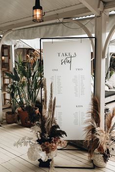 there is a sign that says takla sea on it and some plants in vases