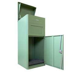 an open green metal box with a dog bed inside and the door opened wide open