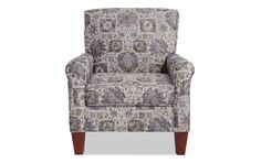 the arm chair is upholstered with an intricate floral pattern and wooden legs,