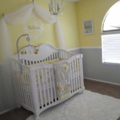 a white crib in a yellow and gray nursery