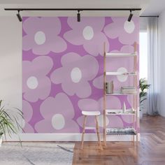 a pink and white flower wall mural in an empty room with a ladder to the side