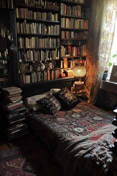 a bed sitting in front of a book shelf filled with lots of books next to a window