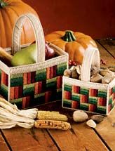 two baskets filled with fruit and vegetables on top of a wooden table next to pumpkins