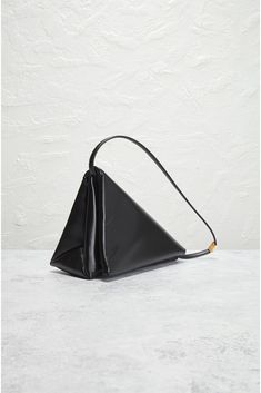 Find MARNI Prisma Triangle Bag on Editorialist. Marni Prisma Triangle Bag in Black Leather exterior with vegan leather lining. Made in Italy. Flap top with zip closure. Two compartments. Gold-tone hardware. Measures approx 11 W x 7.25 H x 4.75 D Shoulder strap with a 8.75 drop. Excellent. Minor signs of wear throughout. Original brand box and authenticity card not included. FNEF-MY7. SBMQ0087U0-P6039-00N99. About the designer: Pyramid Bag, Marni Bag, Triangle Bag, Gold Sand, Bags Logo, Logo Stamp, Black Bag, Blue Bags, Pyramid