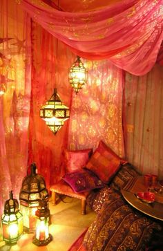 a bed room with lots of pillows and lights