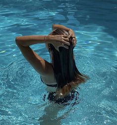 a woman with long hair is in the water