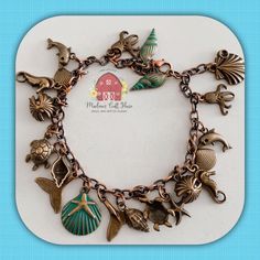 Charming Beach Bracelet  $60 Made to your wrist/ankle measurement.  Free shipping in the US.  An assortment of beach themed, copper charms, dangle from a copper chain, cut to your requested length, which close securely with a lobster clasp.  Charms included: seashells, whale tails, turtles, starfish, dolphins and octopus. Beach Bracelet, Beach Bracelets, Whale Tail, Copper Chain, Beach Themed, Charm Bracelets, Starfish, Octopus, Lobster Clasp