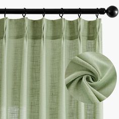 a green curtain hanging from a metal rod