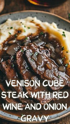 steak with red wine and onion gravy served on mashed potatoes in a bowl