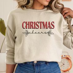 This Christmas Sweatshirt is the perfect gift idea for her, combining festive charm with cozy comfort. This cute Christmas sweatshirt makes a delightful addition to her holiday wardrobe, ensuring she stays warm and stylish throughout the season. T-Shirt Details: -Gildan 18000 Unisex Sweatshirt  -Polyester & Cotton  -Ribbed Knit Collar & Seams -No itchy Side Seams How to order? -Select the color you would like to order -Select the size you would like to order (See measurements details in photo) - Festive Long Sleeve Fall Sweatshirt, Fall Holiday Cotton Sweatshirt, Casual Festive Sweatshirt For Fall, Cotton Sweatshirt For Fall Holiday, Casual Fall Festive Sweatshirt, Festive Christmas Crew Neck Sweatshirt, Casual Christmas Sweatshirt For Festive Occasion, Casual Christmas Festive Sweatshirt, Holiday Long Sleeve Tops As Gifts