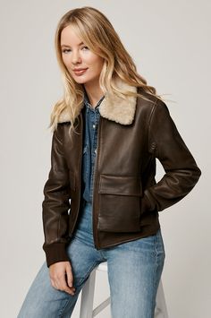 Show off classic bomber style with a modern twist in the Tracy, crafted from distressed cowhide. This beautifully boxy leather bomber features a detachable Australian shearling sheepskin collar, which offers extra warmth and rugged style on chilly days. Knit cuffs and a rear waist insert offer comfortable stretch, while four front pockets lend space for keys and gloves. Sheepskin Coat, Rugged Style, Shearling Coat, Distressed Leather, Leather Jackets Women, Leather Coat, Dream Closet, Leather Women, Bomber Jacket